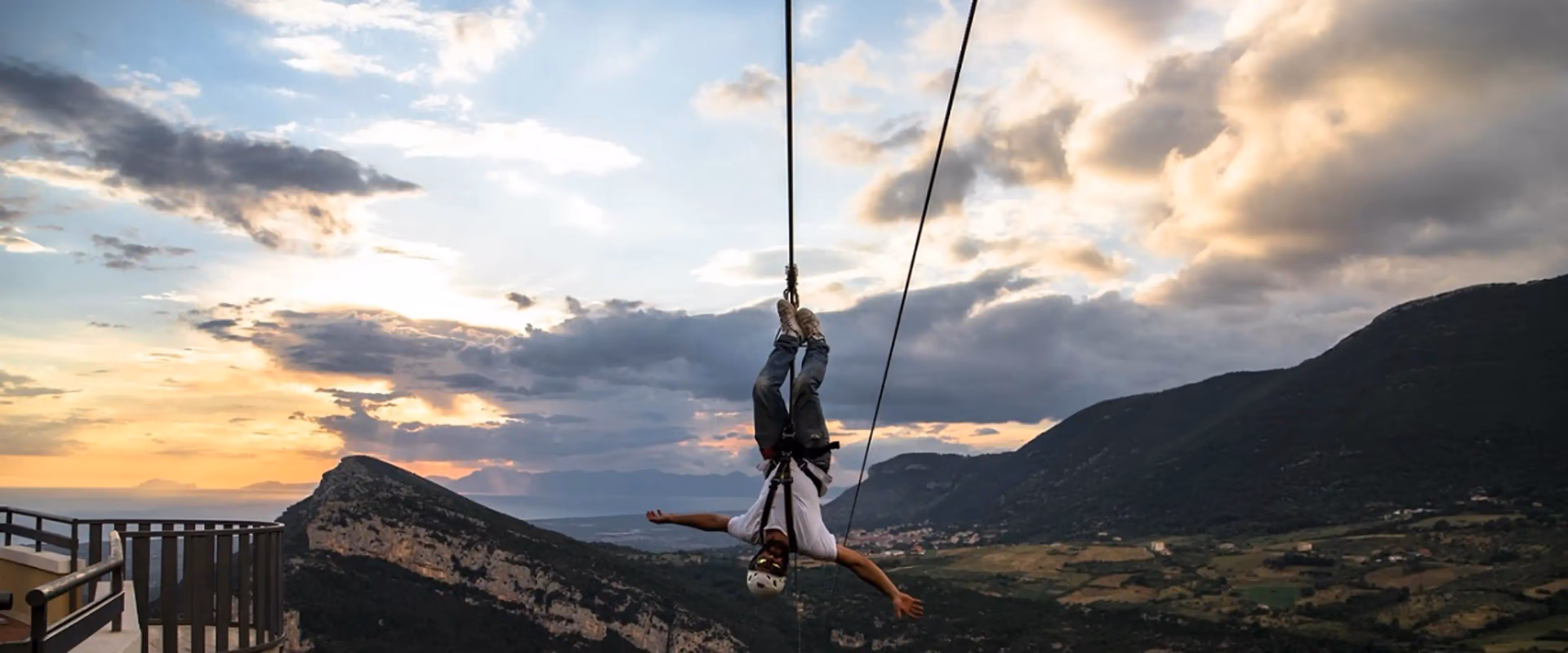Person flying on the Cilento in Volo zipline with panorama in the background